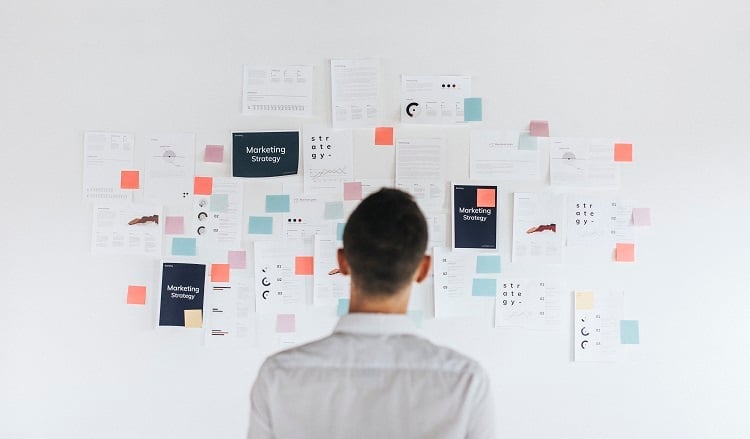 a-casual-business-man-looking-at-a-marketing-plan-C36HWXS