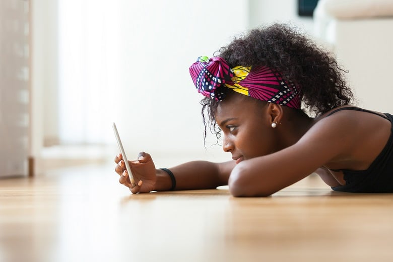african-american-woman-sending-a-text-message-on-a-PRX6KP7