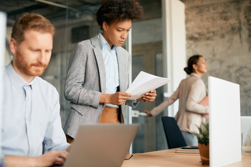 black-female-ceo-analyzing-reports-while-working-a-2022-12-13-21-07-40-utc
