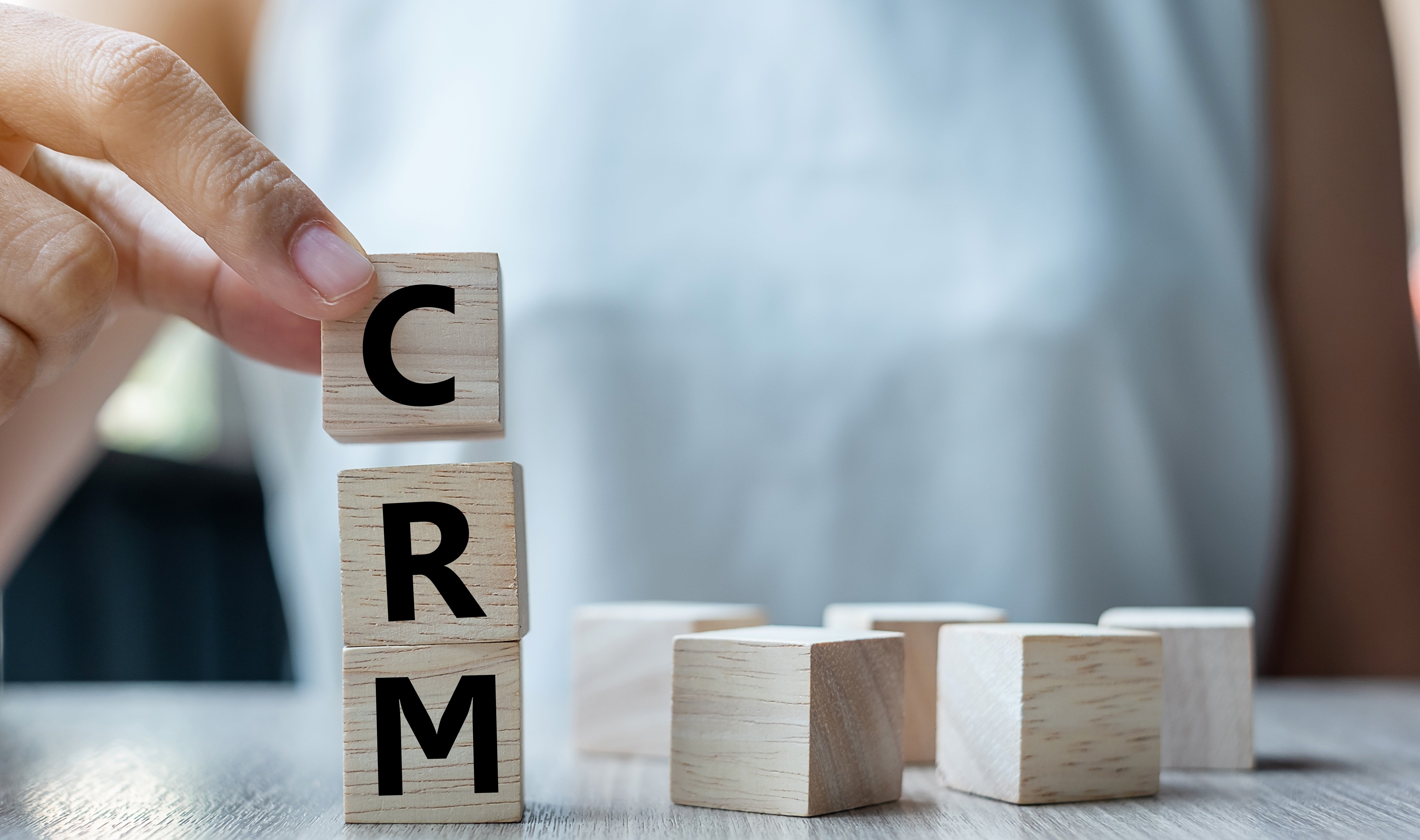business-woman-hand-holding-wooden-cube-with-crm-t-2021-09-01-08-12-30-utc-jpg