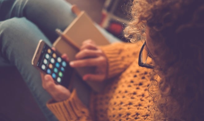 girl checking social media on her phone