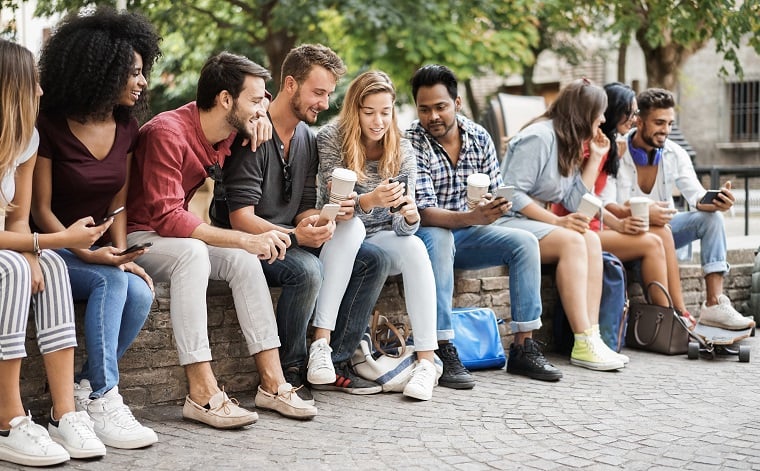 group-of-friends-using-mobile-phones-outdoors-in-c-2021-05-05-19-32-55-utc-jpg
