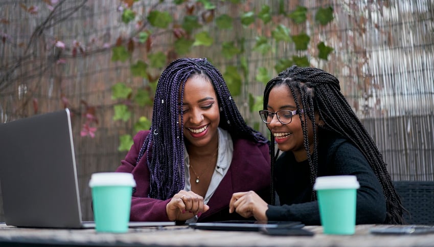 two-smiling-young-women-working-with-various-elect-2022-01-19-00-04-09-utc-jpg